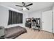 This bedroom has a ceiling fan, black out curtains, and a desk for a computer setup at 2924 W Anderson Dr, Phoenix, AZ 85053
