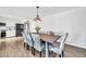 Open dining area with a wooden table, floral patterned chairs, and a view of the modern kitchen at 2924 W Anderson Dr, Phoenix, AZ 85053