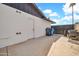 Exterior view of a home showcasing a white door, trash bins, and a barbeque grill at 2924 W Anderson Dr, Phoenix, AZ 85053