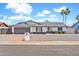 Charming single-story home with a gray roof, a two-car garage, and desert landscaping at 2924 W Anderson Dr, Phoenix, AZ 85053