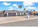 Charming home showcasing palm trees, a gray garage door, and a well-maintained front yard at 2924 W Anderson Dr, Phoenix, AZ 85053
