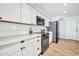 Bright, clean kitchen with white cabinetry, subway tile backsplash and modern appliances at 2924 W Anderson Dr, Phoenix, AZ 85053