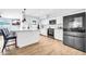 Modern kitchen featuring stainless steel appliances, a large island, and white cabinets at 2924 W Anderson Dr, Phoenix, AZ 85053