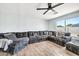 Comfortable living room with a large sectional sofa, ceiling fan, and a bright window at 2924 W Anderson Dr, Phoenix, AZ 85053