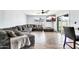 Cozy living room featuring a large sectional sofa, tile floors, sliding glass doors and a mounted television at 2924 W Anderson Dr, Phoenix, AZ 85053