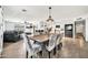 Open concept kitchen, dining, and living space featuring a large sectional sofa and stainless steel appliances at 2924 W Anderson Dr, Phoenix, AZ 85053