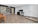 Spacious room with engineered wood floors, barn-door closet, and modern office setup at 2924 W Anderson Dr, Phoenix, AZ 85053