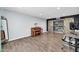 Room with engineered wood floors, barn-door closet, piano, mirror, and modern office setup at 2924 W Anderson Dr, Phoenix, AZ 85053