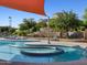 The tranquil community pool includes tiered landscaping, a slide, and a relaxing spa area for residents to enjoy at 310 S San Christo Ln, Casa Grande, AZ 85194