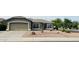 Charming single-story home with desert landscaping, a spacious driveway, and an attached two-car garage at 3176 E Palm Beach Dr, Chandler, AZ 85249