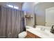 Bathroom with a modern sink, vanity, toilet and a shower with a stylish curtain at 3450 E Milky Way, Gilbert, AZ 85295