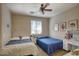 Cozy bedroom featuring two twin beds, ceiling fan and a vanity, ideal for a room at 3450 E Milky Way, Gilbert, AZ 85295