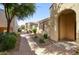 Inviting walkway leading to the arched entryway of this well-maintained home with desert landscaping at 3450 E Milky Way, Gilbert, AZ 85295