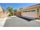 Attached garage with driveway and gate to backyard area, next to the main part of the home at 3450 E Milky Way, Gilbert, AZ 85295