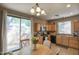 Bright eat-in kitchen featuring black appliances, wood cabinetry, and sliding doors to the backyard at 3450 E Milky Way, Gilbert, AZ 85295