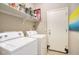 Functional laundry room equipped with a washer, dryer, and storage shelves at 3450 E Milky Way, Gilbert, AZ 85295