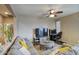 Comfortable living room featuring neutral color scheme, ceiling fan, and adjacent office nook at 3450 E Milky Way, Gilbert, AZ 85295