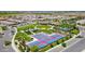 Aerial view showcases community amenities, including a pool, tennis courts, and expansive green spaces for outdoor activities at 36145 N Desert Tea Dr, Queen Creek, AZ 85140
