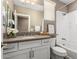 Bathroom featuring granite counters, white cabinets, and a shower-tub combo at 36145 N Desert Tea Dr, Queen Creek, AZ 85140