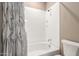 Clean, white bathroom with shower and bathtub, featuring neutral color scheme and modern fixtures at 36145 N Desert Tea Dr, Queen Creek, AZ 85140