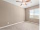 A well-lit bedroom featuring a window that provides natural light and a ceiling fan for air circulation at 36145 N Desert Tea Dr, Queen Creek, AZ 85140