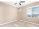 Well-lit bedroom with light-colored carpet and a large window with blinds at 36145 N Desert Tea Dr, Queen Creek, AZ 85140