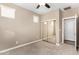 Cozy bedroom with mirrored closet doors and ceiling fan for comfort at 36145 N Desert Tea Dr, Queen Creek, AZ 85140