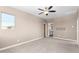 Spacious carpeted bedroom with view to a bathroom and upstairs landing at 36145 N Desert Tea Dr, Queen Creek, AZ 85140