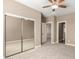 Bedroom with ceiling fan, mirrored closet, and a doorway leading to an adjacent room at 36145 N Desert Tea Dr, Queen Creek, AZ 85140