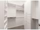 Bright, walk-in closet features built-in shelving, drawers, and plenty of hanging space at 36145 N Desert Tea Dr, Queen Creek, AZ 85140