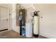 Garage interior with water heater and water softener system for optimal water quality at 36145 N Desert Tea Dr, Queen Creek, AZ 85140