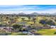 Picturesque golf course view featuring a water feature and mountain views, creating a serene and enjoyable atmosphere at 36145 N Desert Tea Dr, Queen Creek, AZ 85140