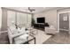 Comfortable living room with plush seating, modern decor, plantation shutters and a ceiling fan at 36145 N Desert Tea Dr, Queen Creek, AZ 85140