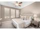 Serene main bedroom with a ceiling fan, neutral tones, and plush furnishings for a relaxing retreat at 36145 N Desert Tea Dr, Queen Creek, AZ 85140