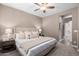 Well-lit main bedroom with soft carpet, neutral colors, and a comfortable bed with decorative pillows at 36145 N Desert Tea Dr, Queen Creek, AZ 85140