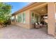 Inviting covered patio with brick pavers, providing a relaxing outdoor space with ample natural light at 36145 N Desert Tea Dr, Queen Creek, AZ 85140