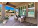 Cozy covered patio with comfortable seating, stylish decor, and a relaxing outdoor ambiance at 36145 N Desert Tea Dr, Queen Creek, AZ 85140