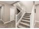Carpeted staircase with white railing in a modern home at 36145 N Desert Tea Dr, Queen Creek, AZ 85140