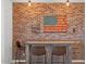 Stylish bar area featuring exposed brick wall and a unique American flag art piece at 4077 S Sabrina Dr # 48, Chandler, AZ 85248