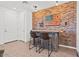 Stylish bar area featuring exposed brick wall and a unique American flag art piece at 4077 S Sabrina Dr # 48, Chandler, AZ 85248