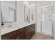Bright bathroom features a brown double vanity, neutral countertop, a glass enclosed shower at 4077 S Sabrina Dr # 48, Chandler, AZ 85248