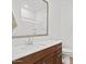 Bright bathroom features a brown vanity, neutral countertop, modern faucet, and large mirror at 4077 S Sabrina Dr # 48, Chandler, AZ 85248