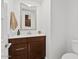 Bright bathroom features a brown vanity, neutral countertop, modern faucet, and large mirror at 4077 S Sabrina Dr # 48, Chandler, AZ 85248