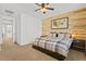 Bedroom boasts wood accent wall, ceiling fan, neutral walls and carpet, and great natural light at 4077 S Sabrina Dr # 48, Chandler, AZ 85248
