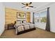 Bedroom boasts wood accent wall, ceiling fan, neutral walls and carpet, and great natural light at 4077 S Sabrina Dr # 48, Chandler, AZ 85248