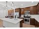 Modern kitchen features stainless steel appliances, wood cabinets, and a bright white island at 4077 S Sabrina Dr # 48, Chandler, AZ 85248