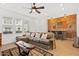Stylish living room featuring a brick accent wall, built-in bar, and comfortable seating area for entertaining at 4077 S Sabrina Dr # 48, Chandler, AZ 85248