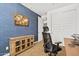 Home office features blue accent wall, built in storage, and modern desk and chair at 4077 S Sabrina Dr # 48, Chandler, AZ 85248