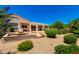 Expansive backyard with a fire pit, desert landscaping, and covered patio at 4633 E Chaparosa Way, Cave Creek, AZ 85331