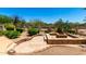 Landscaped backyard features a custom stone fire pit and well-maintained desert landscaping at 4633 E Chaparosa Way, Cave Creek, AZ 85331